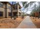 Exterior view of stucco townhouse featuring covered balconies and desert landscaping at 19700 N 76Th St # 1124, Scottsdale, AZ 85255