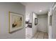 View of hallway leading to the kitchen featuring tile flooring and modern light fixtures at 19700 N 76Th St # 1124, Scottsdale, AZ 85255