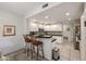 Kitchen area with seating, white cabinets, stainless steel appliances, and dark countertops at 19700 N 76Th St # 1124, Scottsdale, AZ 85255