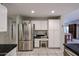 Bright kitchen with white cabinets, stainless appliances, and adjacent desk area at 19700 N 76Th St # 1124, Scottsdale, AZ 85255