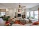 Comfortable living room featuring a cozy fireplace, ceiling fan, and bright natural light at 19700 N 76Th St # 1124, Scottsdale, AZ 85255