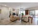 Open-concept living area with cozy fireplace, glass shelving, and a sliding glass door leading to a patio at 19700 N 76Th St # 1124, Scottsdale, AZ 85255