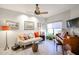 This living room features a comfortable sofa, a ceiling fan, and a piano at 19700 N 76Th St # 1124, Scottsdale, AZ 85255