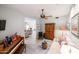 This living room features an open floor plan, a piano, and a ceiling fan at 19700 N 76Th St # 1124, Scottsdale, AZ 85255