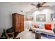 This cozy living room features warm lighting, a comfortable sofa, and an armoire at 19700 N 76Th St # 1124, Scottsdale, AZ 85255