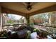 Cozy outdoor patio area with cushioned seating, ceiling fan, and neighborhood views at 19700 N 76Th St # 1124, Scottsdale, AZ 85255