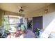 Inviting covered patio featuring a ceiling fan, comfortable seating, and desert landscaping at 19700 N 76Th St # 1124, Scottsdale, AZ 85255