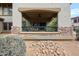 A covered patio with fan, stone accents, iron railing, and desert landscaping at 19700 N 76Th St # 1124, Scottsdale, AZ 85255