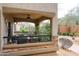 Covered outdoor patio featuring a ceiling fan, stone accents, and desert landscaping at 19700 N 76Th St # 1124, Scottsdale, AZ 85255