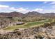 Aerial view showcasing the nearby desert landscape, open space, golf course, and mountains at 20897 W Edith Way, Buckeye, AZ 85396