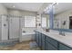 Spacious bathroom with dual sinks, a glass block window, and separate shower and tub at 20897 W Edith Way, Buckeye, AZ 85396