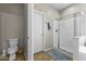 Bathroom featuring a glass shower, tile floors, and a toilet at 20897 W Edith Way, Buckeye, AZ 85396