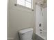 A bright bathroom featuring a white toilet and shower with a modern showerhead at 20897 W Edith Way, Buckeye, AZ 85396