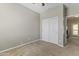 A spare bedroom featuring a closet and neutral-colored walls and carpet at 20897 W Edith Way, Buckeye, AZ 85396