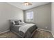 Cozy bedroom with a ceiling fan, carpeted floor and large window for natural light at 20897 W Edith Way, Buckeye, AZ 85396