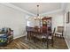Spacious dining room with a dark wood table, upholstered chairs, chandelier, and built-in china cabinet at 20897 W Edith Way, Buckeye, AZ 85396