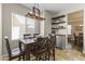 Cozy dining room with a wooden table, chairs, window, decorative lighting, and floating shelves at 20897 W Edith Way, Buckeye, AZ 85396