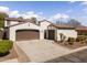 Charming home showcasing a two-car garage and ample driveway space for convenient parking at 20897 W Edith Way, Buckeye, AZ 85396