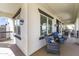 Relaxing front porch featuring comfortable seating, stylish windows, and charming decor at 20897 W Edith Way, Buckeye, AZ 85396