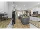 Well-lit kitchen with granite countertops, stainless steel appliances, and an island with seating at 20897 W Edith Way, Buckeye, AZ 85396