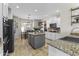 Open kitchen with granite countertops, stainless steel appliances, and an adjacent dining area at 20897 W Edith Way, Buckeye, AZ 85396