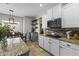 Bright kitchen with white cabinets, granite countertops, stainless steel appliances, and a cozy breakfast nook at 20897 W Edith Way, Buckeye, AZ 85396
