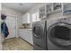 Well-equipped laundry room with modern washer and dryer, cabinetry and ample counter space at 20897 W Edith Way, Buckeye, AZ 85396