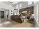 Spacious living room features a wood accent wall, entertainment center, and leather furniture, creating a cozy gathering space at 20897 W Edith Way, Buckeye, AZ 85396