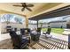 Inviting covered patio with comfortable seating, fire features, and outdoor kitchen for relaxation and entertaining at 20897 W Edith Way, Buckeye, AZ 85396