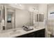 Bathroom with a double sink vanity with black cabinets and a large mirror at 22318 S 226Th Pl, Queen Creek, AZ 85142
