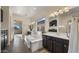 This primary bathroom features a soaking tub, black cabinets, and a double sink vanity with a large window at 22318 S 226Th Pl, Queen Creek, AZ 85142