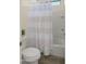 Bathroom featuring a tub with tiled walls and a striped shower curtain at 22318 S 226Th Pl, Queen Creek, AZ 85142
