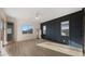 This bedroom features a wood accent wall, sleek floors, and abundant natural light from the windows at 22318 S 226Th Pl, Queen Creek, AZ 85142