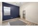 Stylish bedroom with a blue accent wall, wood-look flooring, and a walk-in closet at 22318 S 226Th Pl, Queen Creek, AZ 85142