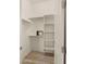 Walk-in closet with shelving and wood-look flooring at 22318 S 226Th Pl, Queen Creek, AZ 85142