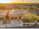Aerial shot showcases a well-maintained home with a three-car garage and manicured landscaping at 22318 S 226Th Pl, Queen Creek, AZ 85142