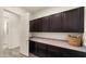Laundry room with dark cabinetry and ample counter space at 22318 S 226Th Pl, Queen Creek, AZ 85142