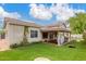 Charming home exterior featuring a covered patio, manicured artificial turf, and well-maintained landscaping at 2321 N Glenview --, Mesa, AZ 85213
