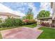Expansive backyard featuring artificial grass and a covered patio surrounded by colorful landscaping at 2321 N Glenview --, Mesa, AZ 85213