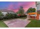 Spacious backyard with manicured artificial turf, covered patio, mature trees, and vibrant bougainvillea at 2321 N Glenview --, Mesa, AZ 85213