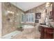 Luxurious bathroom with tiled walls, walk-in shower, and soaking tub at 2321 N Glenview --, Mesa, AZ 85213