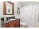 This bathroom features a wood vanity with a black countertop and decorative shower curtain at 2321 N Glenview --, Mesa, AZ 85213