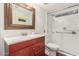 Bathroom with a wood vanity, white countertop, framed mirror, and glass shower doors at 2321 N Glenview --, Mesa, AZ 85213