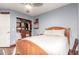 Bedroom features a wood bed frame, and an open closet with drawers and shelves at 2321 N Glenview --, Mesa, AZ 85213