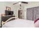 Bedroom featuring a white bed frame, ceiling fan, and a black dresser with a mounted television at 2321 N Glenview --, Mesa, AZ 85213