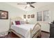 Bedroom with a light wooden bed frame, matching bedside table, and shuttered windows at 2321 N Glenview --, Mesa, AZ 85213