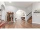Open entryway boasting hardwood floors, staircase, and a view to the front door and arched ceilings at 2321 N Glenview --, Mesa, AZ 85213
