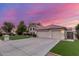 Exterior view featuring a three-car garage, well-manicured lawn, and neutral color palette at 2321 N Glenview --, Mesa, AZ 85213