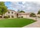 Charming single-Gathering home featuring a manicured front yard with three-car garage and neutral-colored exterior at 2321 N Glenview --, Mesa, AZ 85213