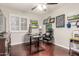 Home office features a desk, chair, and shuttered window with wood floors at 2321 N Glenview --, Mesa, AZ 85213